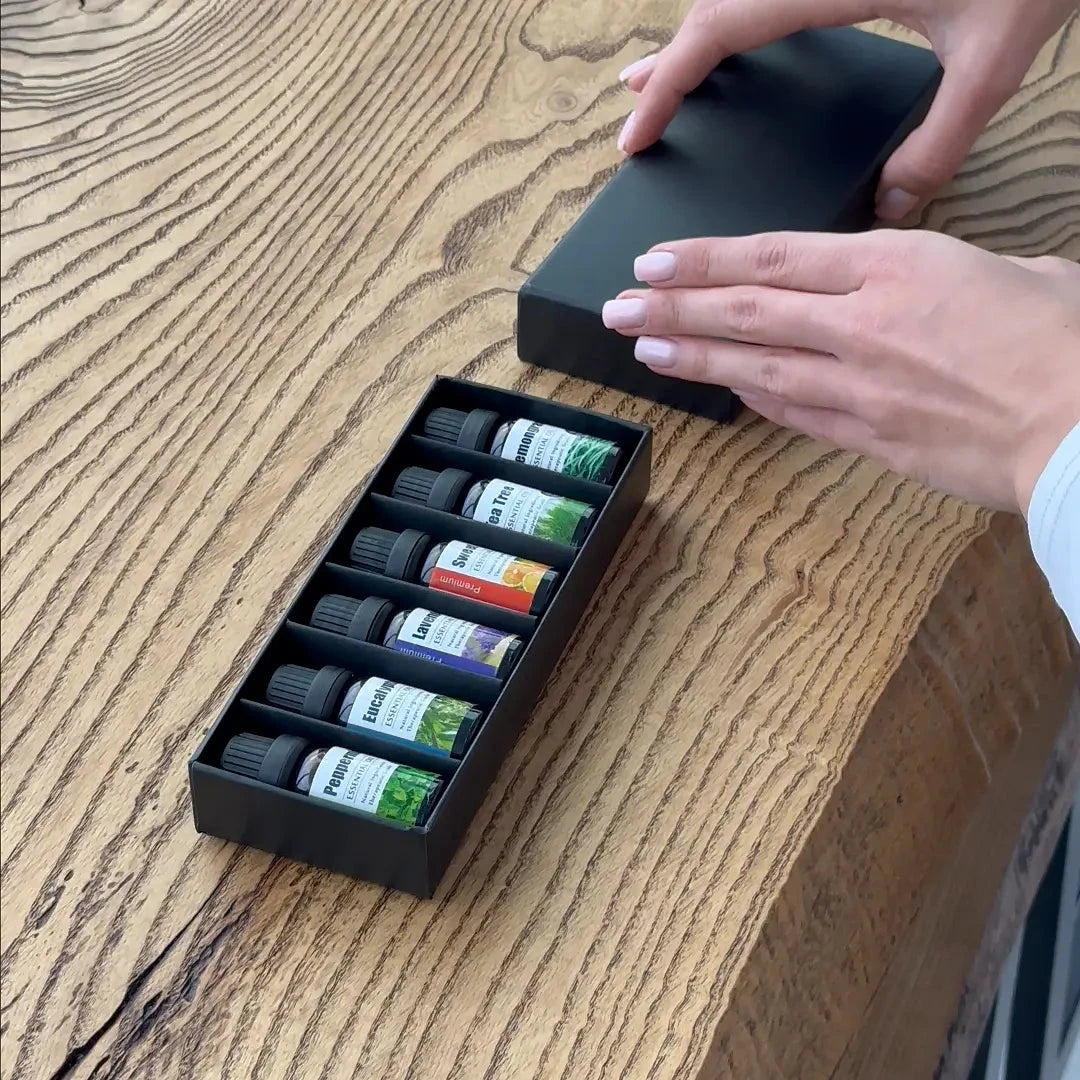 Essential Oils Set of 6 in black box on wooden table